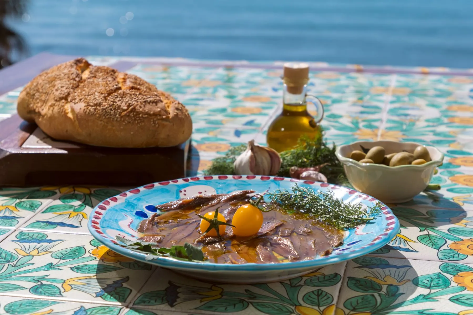 A plate of anchovies by the sea
